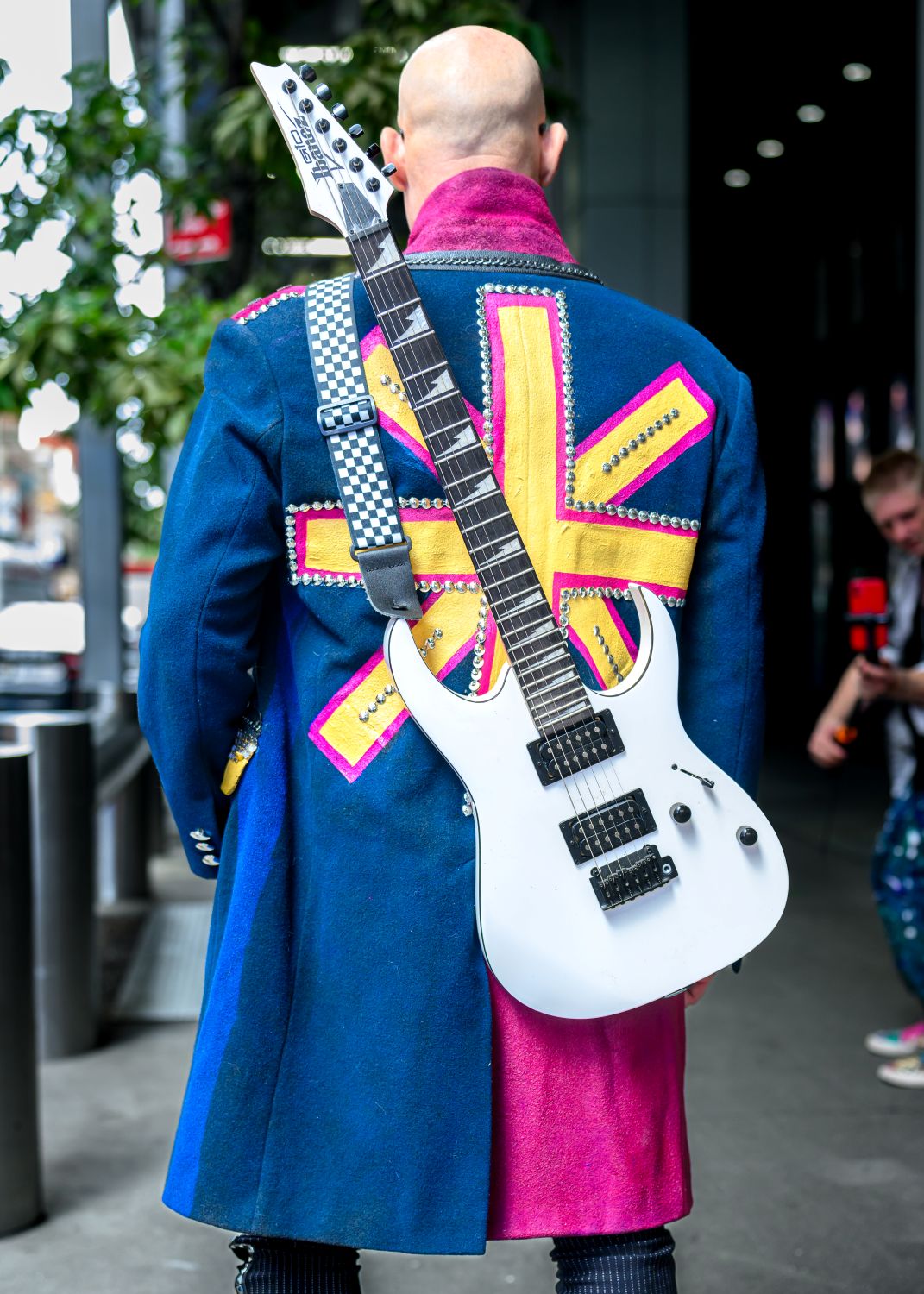 Model wearing upcycled punk jacket with Ibanez electric guitar - fashion by Unique Custom Threads